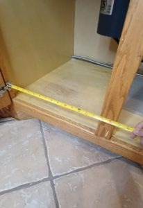 Measure the inside width and depth of your sink cabinet