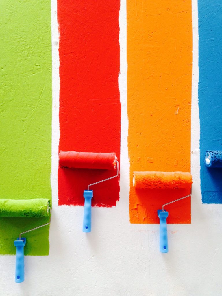 paint rollers with colors on wall